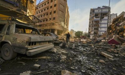 Residents run for cover following an Israeli airstrike in Dahiyeh, Beirut, Lebanon