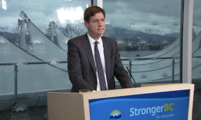 David Eby speaking at a podium