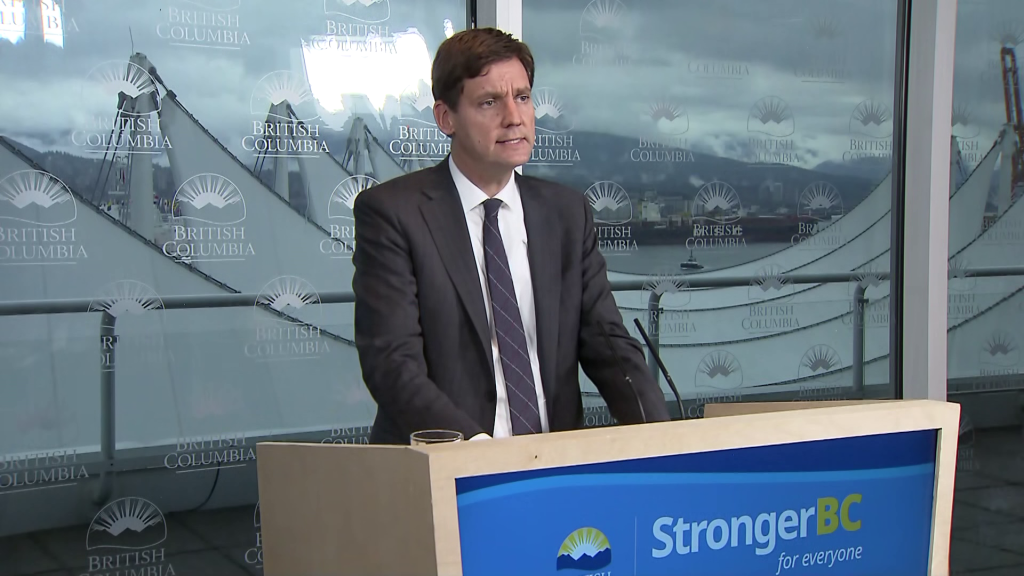 David Eby speaking at a podium