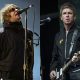 Britpop giants Oasis will play Toronto next August. Liam Gallagher performs at the Reading Music Festival, England on Aug. 29, 2021, left, and Noel Gallagher performs at the Glastonbury Festival in Worthy Farm, Somerset, England, on June 25, 2022.