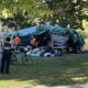 Security personnel are present as City of Toronto workers work to remove an encampment at Allan Gardens