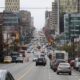 Cars drive down Broadway in Vancouver, with buildings lining either side of the road