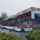 A Coquitlam strip mall remains fenced off on Jan. 5, 2025, a week after a destructive fire.