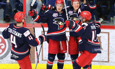 FILE - Players with the Brooks Bandits celebrate a goal during regular season play