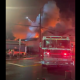 Flames can be seen as fire crews battle a fire at the Super Grocer and Pharmacy in the city's Steveston neighbourhood Friday evening.