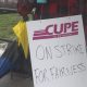 A CUPE 4500 member holds up a sign at a picket line after a 48-hour strike, halting bus and SeaBus services, began the morning of Monday, Jan. 22, 2024.