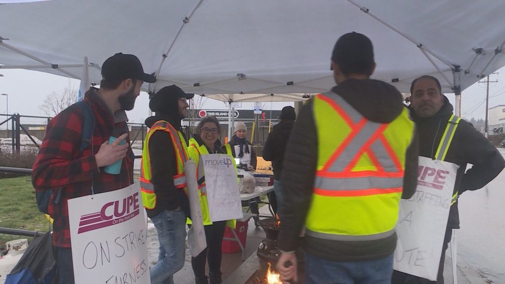 CUPE 4500 members with signs at a picket line after a 48-hour strike, halting bus and SeaBus services, began the morning of Monday, Jan. 22, 2024.