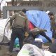 City of Vancouver Park Rangers and Vancouver Police officers dismantle tents at Oppenheimer Park in Vancouver