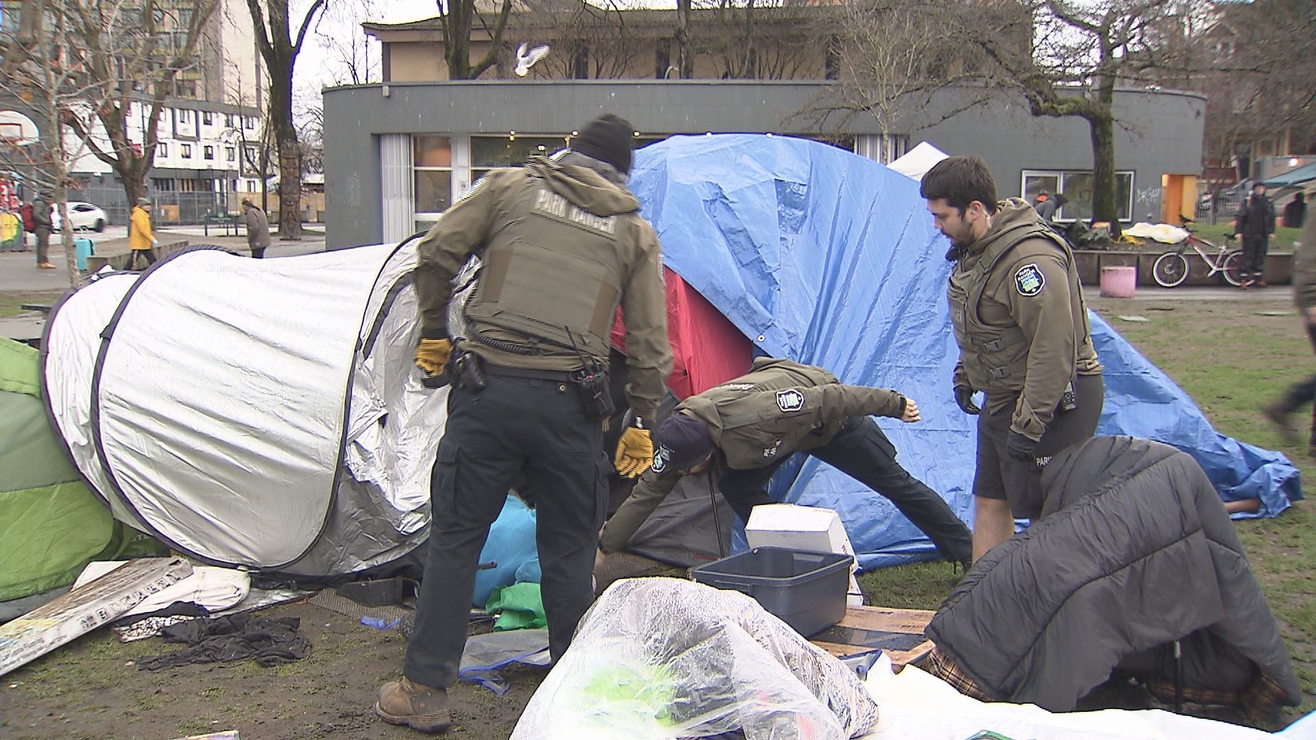 City of Vancouver Park Rangers and Vancouver Police officers dismantle tents at Oppenheimer Park in Vancouver