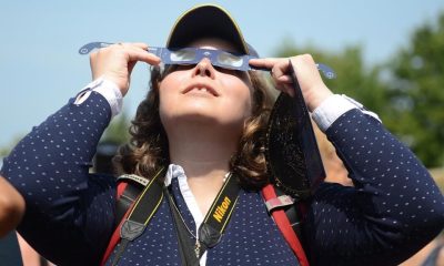 Observers watch a solar eclipse at the Canadian National Exhibition in Toronto on Aug. 21, 2017