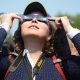 Observers watch a solar eclipse at the Canadian National Exhibition in Toronto on Aug. 21, 2017