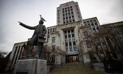 A seagull stands atop a statue of Captain George Vancouver outside Vancouver City Hall, on Saturday, Jan. 9, 2021