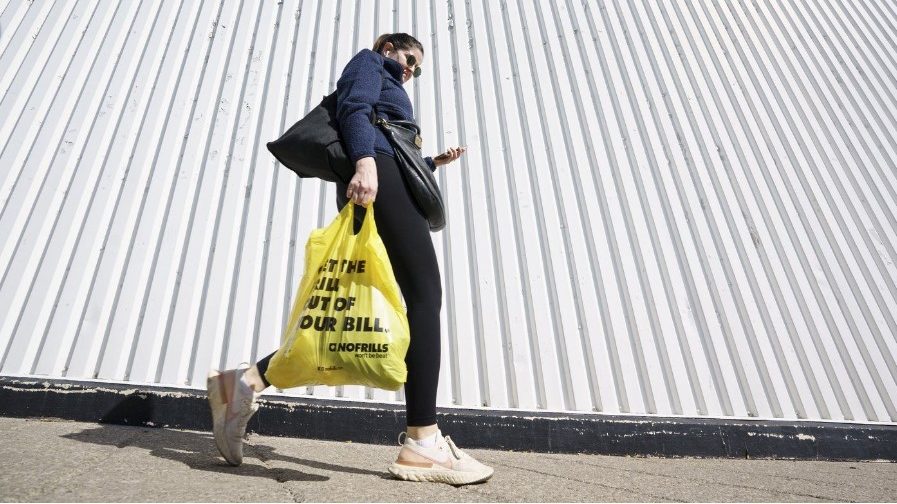 A person leaves a Toronto supermarket with groceries on Oct. 5, 2022