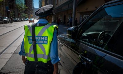 A parking enforcement officer is seen in downtown Toronto.