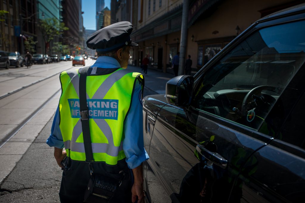 A parking enforcement officer is seen in downtown Toronto.