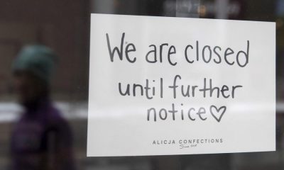 A sign on a shop window indicates the store is closed in Ottawa