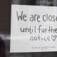 A sign on a shop window indicates the store is closed in Ottawa