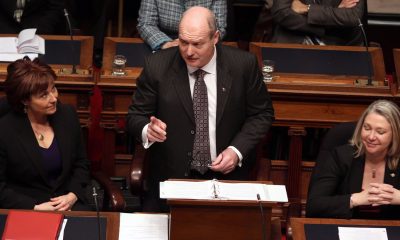 FILE - Then B.C. Finance Minister Mike de Jong, tables the budget in the Legislative Assembly in Victoria, B.C., in a February 17, 2015, file photo. THE CANADIAN PRESS/Chad Hipolito, File