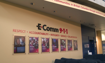 E-Comm 9-1-1 office pictured with a sign that says respect, accountability, integrity, service, and collaboration on the wall.