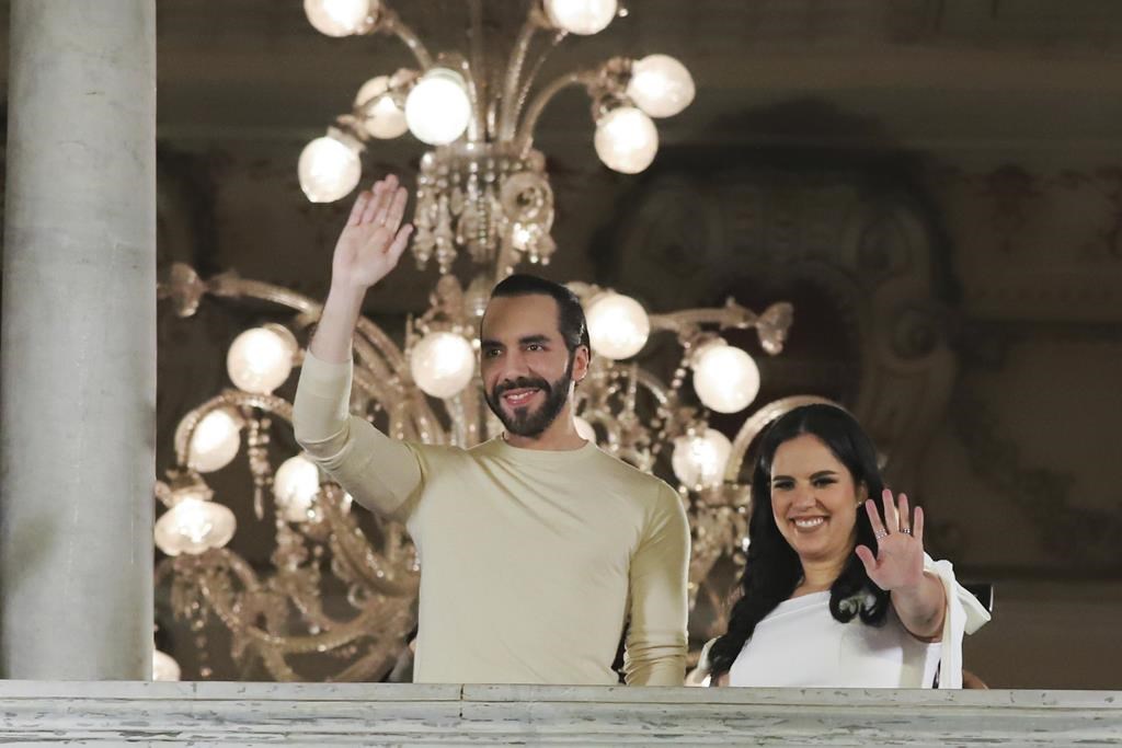 El Salvador President Nayib Bukele, left, accompanied by his wife Gabriela Rodriguez, wave to supporters from the balcony of the presidential palace in San Salvador, El Salvador, after polls closed for general elections on Sunday, Feb. 4, 2024. El Salvador President Bukele and his New Ideas party have won the supermajority the leader needs in Congress to govern as he pleases, electoral officials announced Monday, Feb. 19