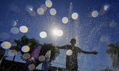 FILE - A youth cools off at the "Parque de Agua" public water park on a hot summer day in Santiago, Chile, Jan. 31, 2024