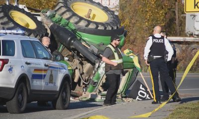 A tractor travelling on Highway 1 hit a police cruiser on Nov. 25, 2023, causing the tractor to roll over, according to Surrey RCMP