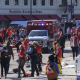 Police clear the area following a shooting at the Kansas City Chiefs NFL football Super Bowl celebration in Kansas City, Mo., Wednesday, Feb. 14, 2024. (AP Photo/Reed Hoffmann)