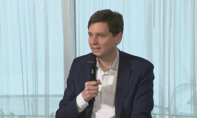 B.C. Premier David Eby speaks into a microphone.