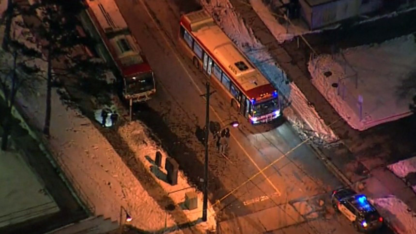 Police tape surrounds a TTC bus on Driftwood Avenue