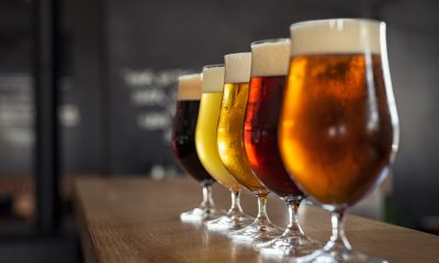 Beer glasses are seen on a bar counter