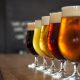 Beer glasses are seen on a bar counter