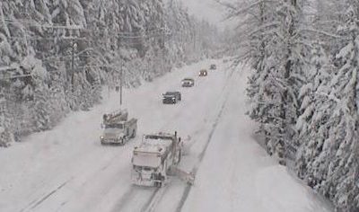 File image of Highway 99 near Whistler covered in snow. Trucks and cars driving through the snow.