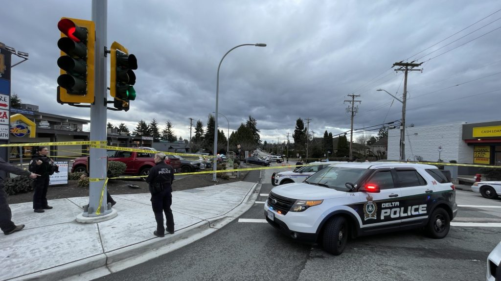 Officers with the Surrey RCMP and Delta Police Department block off a section of Scott Road near 84th Avenue after a daytime shooting left one person hurt on Feb. 2, 2024