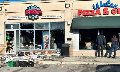 Toronto fire officials inspect the damage at a restaurant on Overlea Boulevard