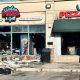 Toronto fire officials inspect the damage at a restaurant on Overlea Boulevard