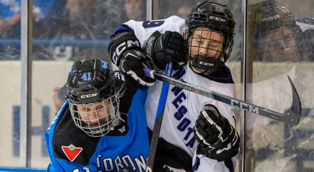 Toronto's Brittany Howard (41) drives Minnesota's Maggie Flaherty (19) into the boards during second period PWHL action in Toronto on Wednesday May 1, 2024