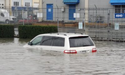 A vehicle is seen partially submerged in a flooded area near Still Creek Drive in Burnaby on Oct. 19, 2024.