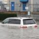 A vehicle is seen partially submerged in a flooded area near Still Creek Drive in Burnaby on Oct. 19, 2024.