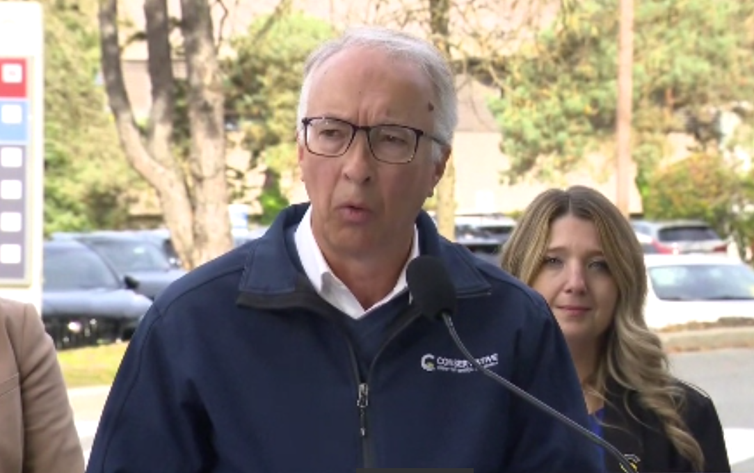 John Rustad speaks at a podium