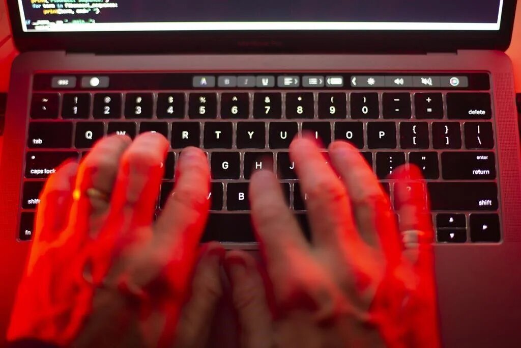 Hands use a laptop to code