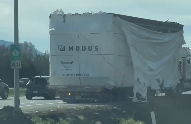 A damaged truck sits idle on Highway 1