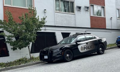 Vancouver Police stationed outside a building near Kingsway and Melbourne Street on Thursday October 3, 2024.