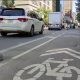 A designated cycling lane is seen on a busy street in downtown Toronto.