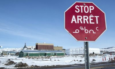 A stop sign in English, French and Inuktut syllabics is seen in Iqaluit, on April 25, 2015