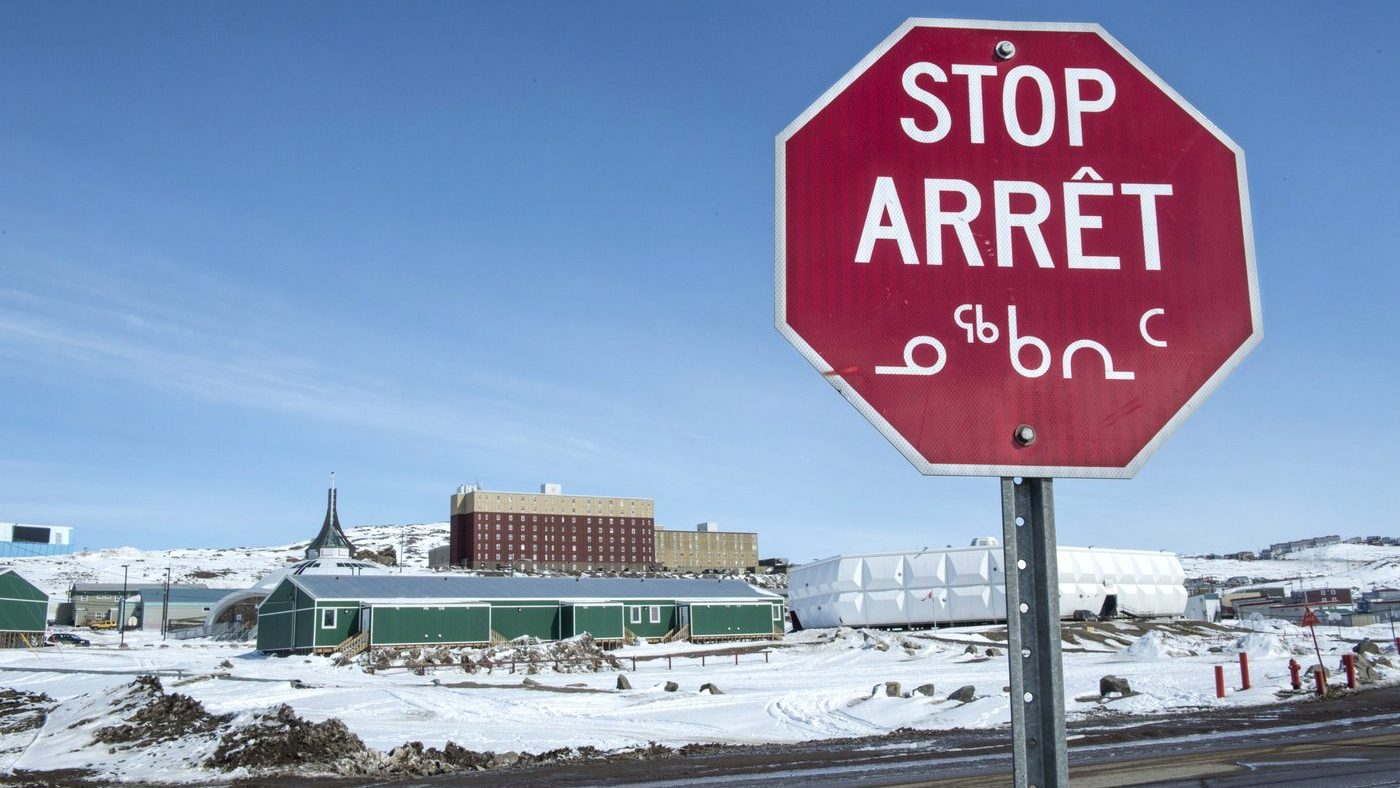 A stop sign in English, French and Inuktut syllabics is seen in Iqaluit, on April 25, 2015