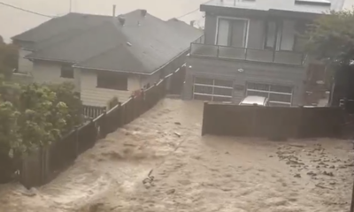 Flood waters pour over a yard in Deep Cove during an atmospheric river weather event Oct. 19, 2024.