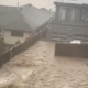 Flood waters pour over a yard in Deep Cove during an atmospheric river weather event Oct. 19, 2024.