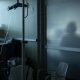 A health-care worker is silhouetted behind a glass panel at a hospital in Sarnia