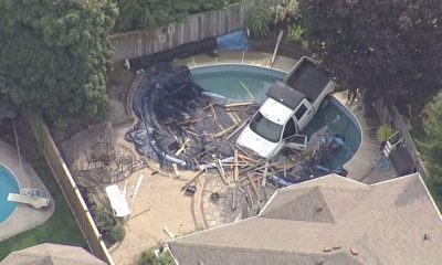 Police say a vehicle hit a pedestrian, then went through a fence and ended up in a backyard pool in Whitby on Oct. 11, 2024