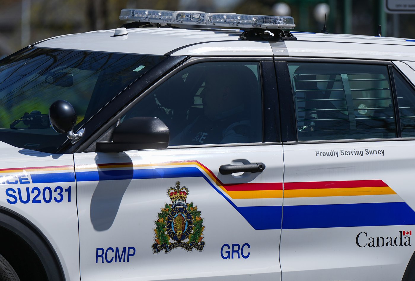 A Surrey RCMP officer drives a police vehicle in Surrey, B.C., on Friday, April 28, 2023. THE CANADIAN PRESS/Darryl Dyck